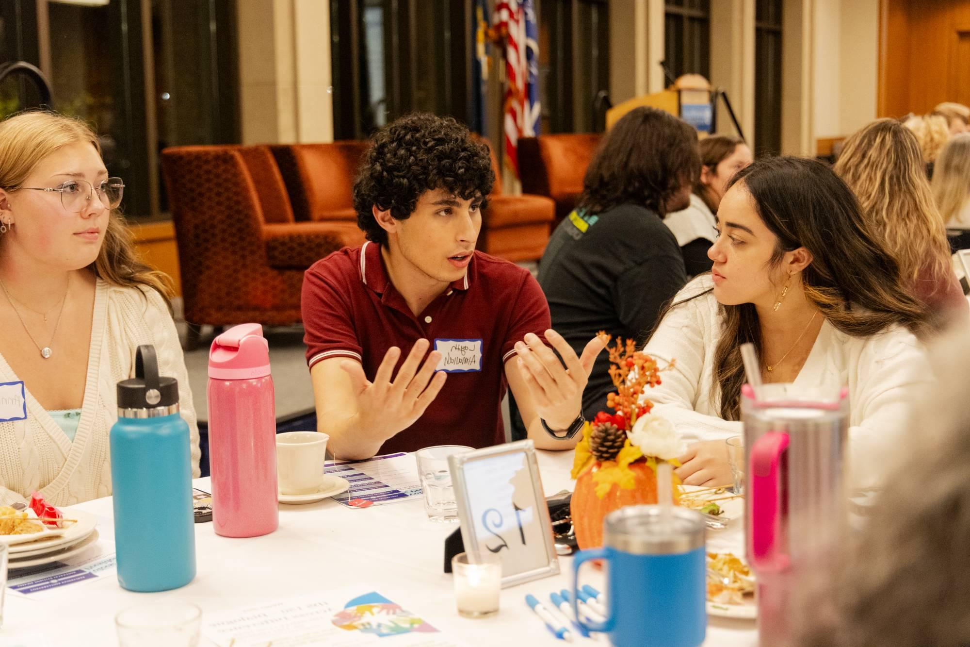 A table of attendees in deep conversation